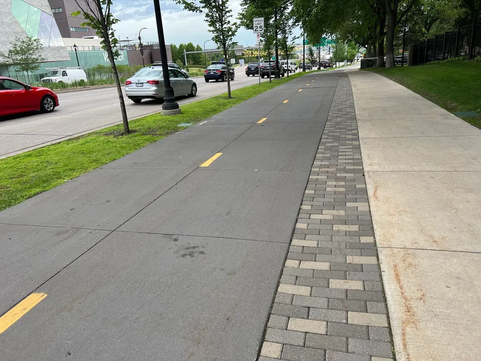 protected bike lane extension of sidewalk