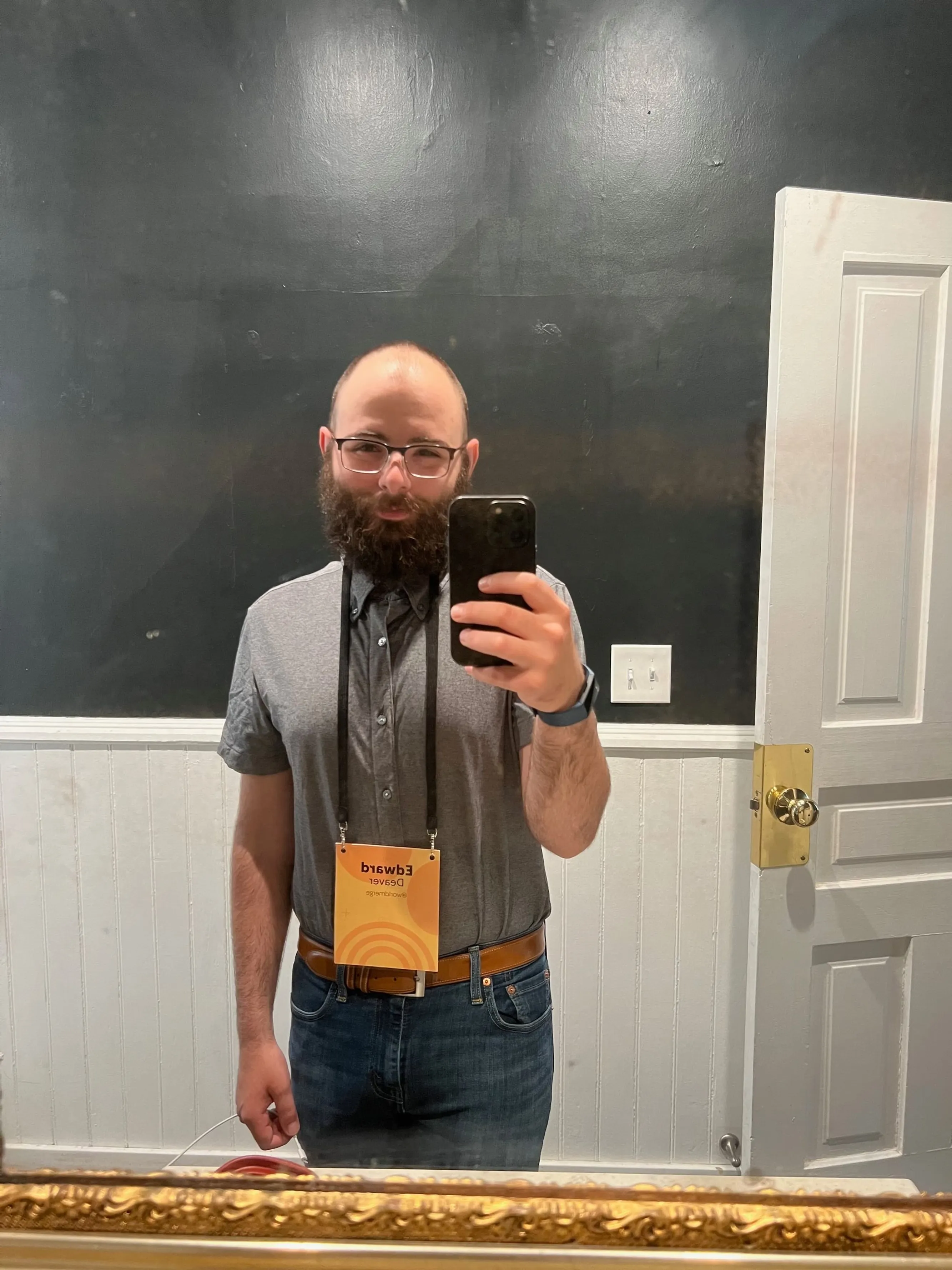 Bald man with beard takes a selfie